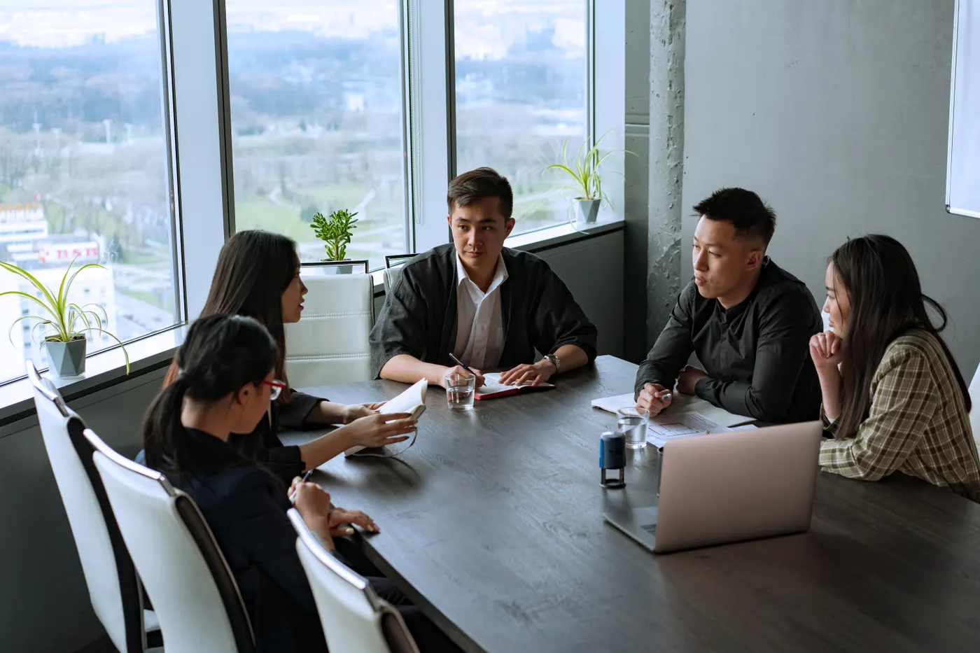 Small team discussing plans around a table